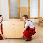 Trusted movers NJ loading moving truck with organized boxes and furniture using professional straps and padding