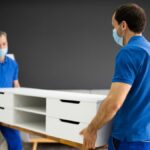 Local NJ movers unloading boxes from a moving van